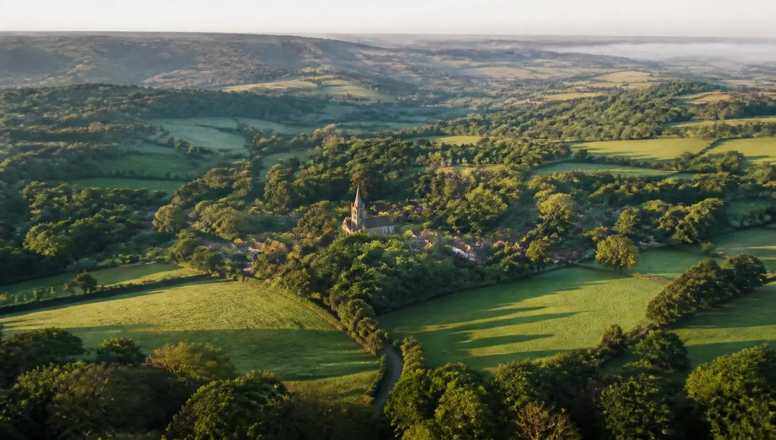 Rolling wooded countryside, hedgerows and village rooftops typical of the landscape around Westerham